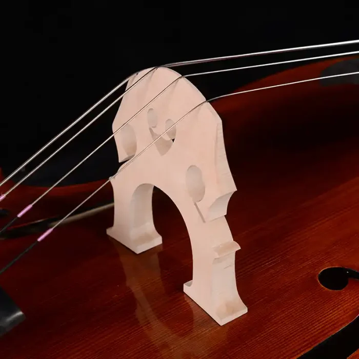 Professional double bass bridge close-up on spruce top, clean fit and string alignment