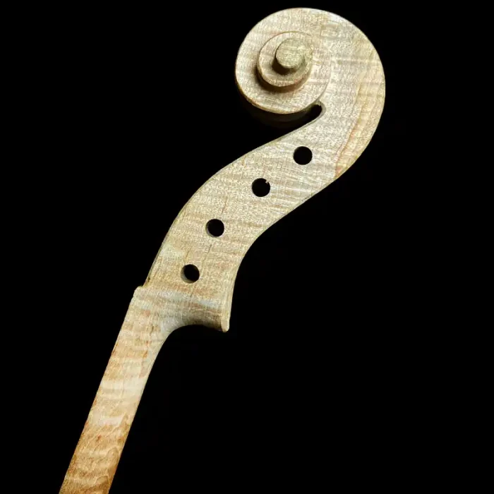 Close-up side view of the hand-carved flamed maple scroll and pegbox of unfinished violin LVW-03. Premium solid wood blank for professional luthier wholesale.